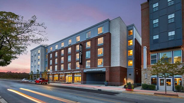 A multi-story hotel with a modern design, featuring a mix of brick and glass facades, and a prominent signage for 'Townplace Suites by Marriott'. - TownePlace Suites by Marriott Columbus North - OSU (Columbus)