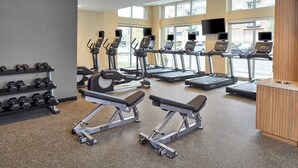 A gym with treadmills, dumbbells, and weight benches. - TownePlace Suites by Marriott Columbus North - OSU (Columbus)