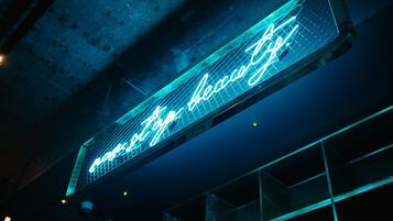 A neon sign with the text "Neon Lights" in a modern, industrial setting.