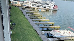 A riverside dock with wooden benches and a boat. - Lake house - unit 309 (Willis)