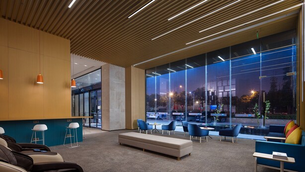 A modern lobby with a reception desk, seating area, and large windows offering a view of the street. - Holiday Inn Express Changsha South Railway Station by IHG (Changsha)