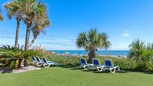 A beachside lounge area with sun loungers and palm trees. - Sand Dunes Resort North Tower, 17th Floor, Pools! (Myrtle Beach)