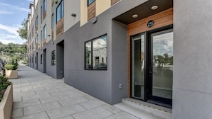 A modern building with a grey facade, large windows, and a number 235 sign. - Private Elevator in Hot South Slope (Asheville)
