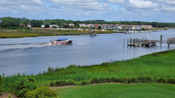 A river with a boat named 'Sea Thunder' and a dock with a pier. - Harbor Breeze - Great Views of Intracoastal 3BR/3BA (North Myrtle Beach)