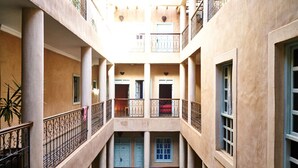 A multi-level courtyard with balconies, columns, and a central open space. - Bienvenue au Riad Taroudant ! (Taroudant)