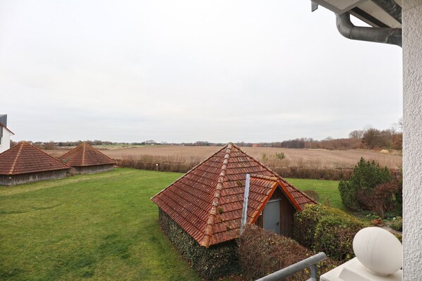 A rural landscape with traditional thatched-roof cottages.