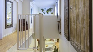 A modern interior with a staircase, a wooden door, and a world map on the ceiling. - Cozy duplex with Terrace, 1 Bedrooms, 2+2 Pax, Central Market, old town (Valencia)