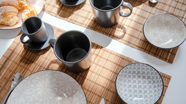 A table set with plates, bowls, cups, and cutlery. - Downtown Rooms (Como)