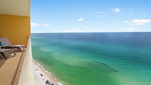 A balcony with a view of a beach and the ocean. - 1704-17th Flr-BEACH CHAIRS & UMBRELLA INCL-HOT TUB-Outdoor POOL-BEACH VIEWS (Panama City Beach)