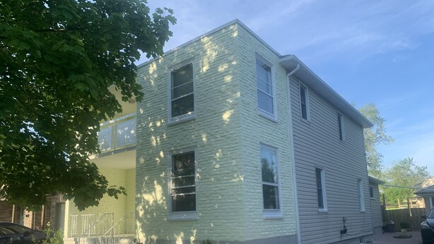 A two-story building with a brick facade and a flat roof. - Be At Home Away From Home III (Welland)