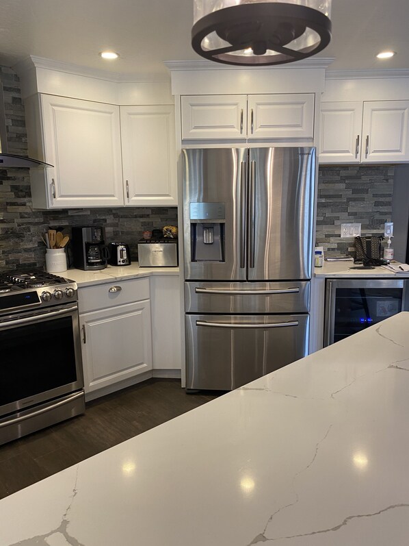Enjoy cooking in this well-equipped kitchen with a refrigerator, double oven, and oven.