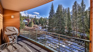 A balcony with a view of a snowy forest and a mountain in the background. - Old Town Winter Park  | 2 Minutes to the Resort (Winter Park)