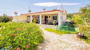 A house with a covered porch, potted plants, and a gravel pathway. - Cubo's Finca Fernando / private pool / free wifi (Coín)