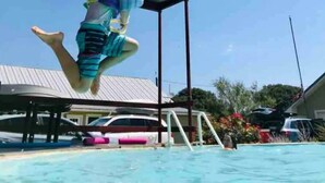 A person jumping off a roof into a swimming pool. - Country Home on 33 acres,  sleeps 18, On the San Saba River! (Voca)