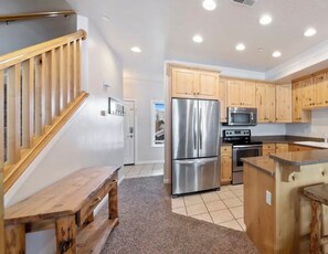 Enjoy cooking in this well-equipped kitchen with a refrigerator, microwave, and sink.