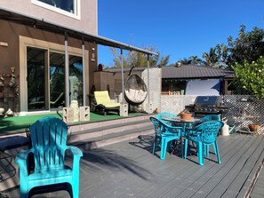 Enjoy al fresco dining and socializing in this outdoor patio area, complete with a grill and comfortable seating options.