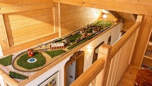 A model train layout with a circular track, buildings, and a small town scene.