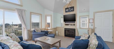 Télévision à écran plat, cheminée, baby-foot