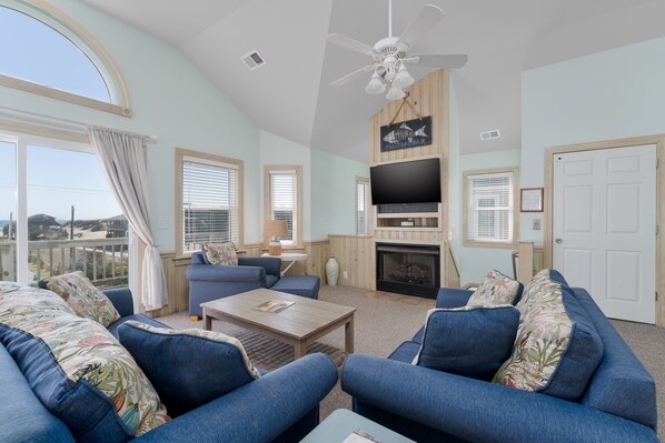 Télévision à écran plat, cheminée, baby-foot