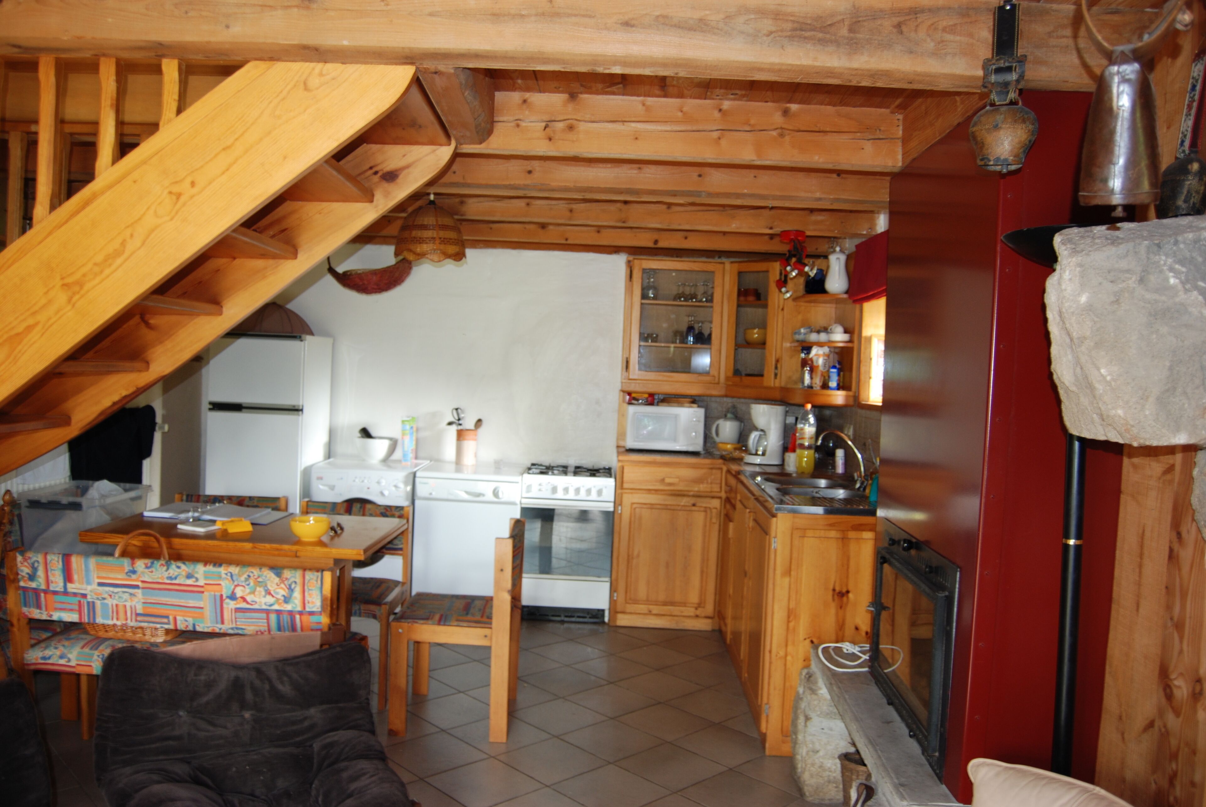 A kitchen with wooden cabinets, a stove, and a microwave.