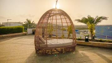 Outdoor pool, pool umbrellas, lifeguards on site