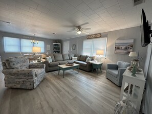 Relax in this inviting living room with a sofa, chair, coffee table, and wall-mounted TV.