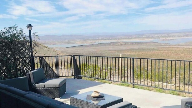 An outdoor seating area with a view of a distant landscape. - PERFECT DESERT OASIS~lake~jet ski~boat (Truth or Consequences)
