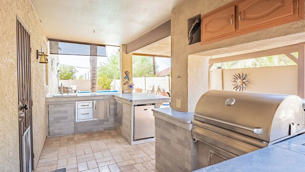 A compact kitchen with a built-in grill, a sink, and a dishwasher. - Great Value, near golf,hiking: Superstition Escape (Gold Canyon)