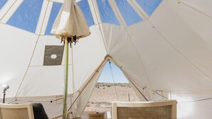 A tent with a view of a desert landscape, a bed, and a chair. - Spacious Bell Tent Rental for Two to Go Glamping in Utah (Monticello)