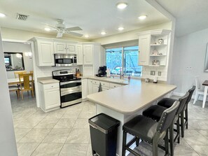 Enjoy cooking in this well-equipped kitchen with a large island, microwave, and oven.