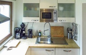 Fridge, stovetop, dishwasher, coffee/tea maker