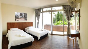 A hotel room with two beds, a wooden headboard, a painting, a desk with a chair, and a large window with curtains. - The Pines (Raub)