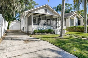 A single-story house with a covered porch, a garage, and a well-maintained lawn.