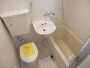 A bathroom with a toilet, sink, and bathtub. - Nagayama Whole Apartment (Asahikawa)