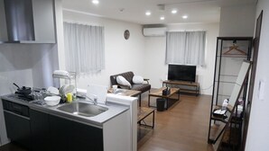 A modern apartment with a kitchen, dining area, and living room. - Nagayama Whole Apartment (Asahikawa)