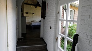 A narrow hallway with a wooden staircase leading to a room with a bed. - Room-room to Rent With own Entrance, liv (Blitterswijck)