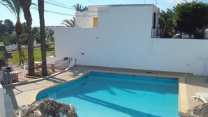 A swimming pool with a white wall and a small deck area. - Impressive in Ground Floor With Terrace of 2 Rooms and Pool (Vera)