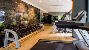 A modern gym with treadmills, dumbbells, and a mirrored wall. - Welcome to the Best and new Apartment to Have Great Trip in Patong Beach (Patong)