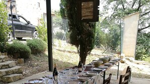An outdoor dining area with a long table set for six, surrounded by wooden chairs. - Room in Holiday House - Double Twin Room With Balcony Pool View (Monte Castello di Vibio)