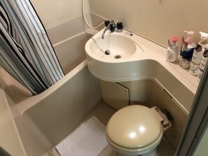 A small bathroom with a toilet, sink, and shower. - Nagayama Apartment Twin (Asahikawa)