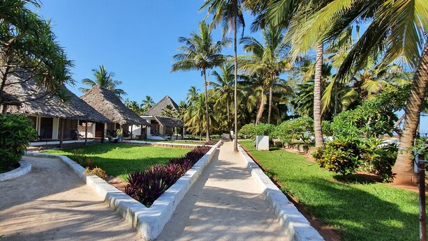 A resort with thatched-roof cottages, a central pathway, and lush greenery. - Mbv Hotel Annex Standard Bungalow (Matemwe)