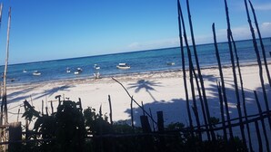 A beach with boats in the water and a clear sky. - Mbv Hotel Annex Standard Bungalow (Matemwe)