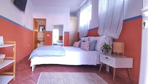 A bedroom with a bed, bedside table, and a window with curtains. - Studio Apartments Roza - A Charming Oasis in the Centre of Makarska (Makarska)