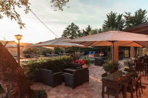 An outdoor patio area with seating, umbrellas, and a pool. - Bb La Mortella With Pool (Roccadaspide)