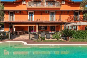 A two-story building with a swimming pool, outdoor seating, and a balcony. - Bb La Mortella With Pool (Roccadaspide)