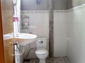 A small, compact bathroom with a white sink, toilet, and shower. - Peaceful Homestay in the Middle of Fruit Garden - Rooms With Private Toilets (Phu Khuong)