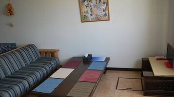 Room A, Non Smoking | Living area | Flat-screen TV