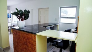 A small office with a desk, chair, and a potted plant. - Room-relaxing Guest House in th Heart of (Cape Town)