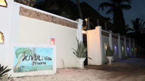 A private villa entrance with a signboard, a potted plant, and a pathway leading to the building. - Room-a Wonderful Beach Property in Diani (Mombasa)