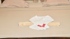 A neatly made bed with a wooden headboard, two pillows, and a folded white towel with a red tag. - Room-a Wonderful Beach Property in Diani (Mombasa)